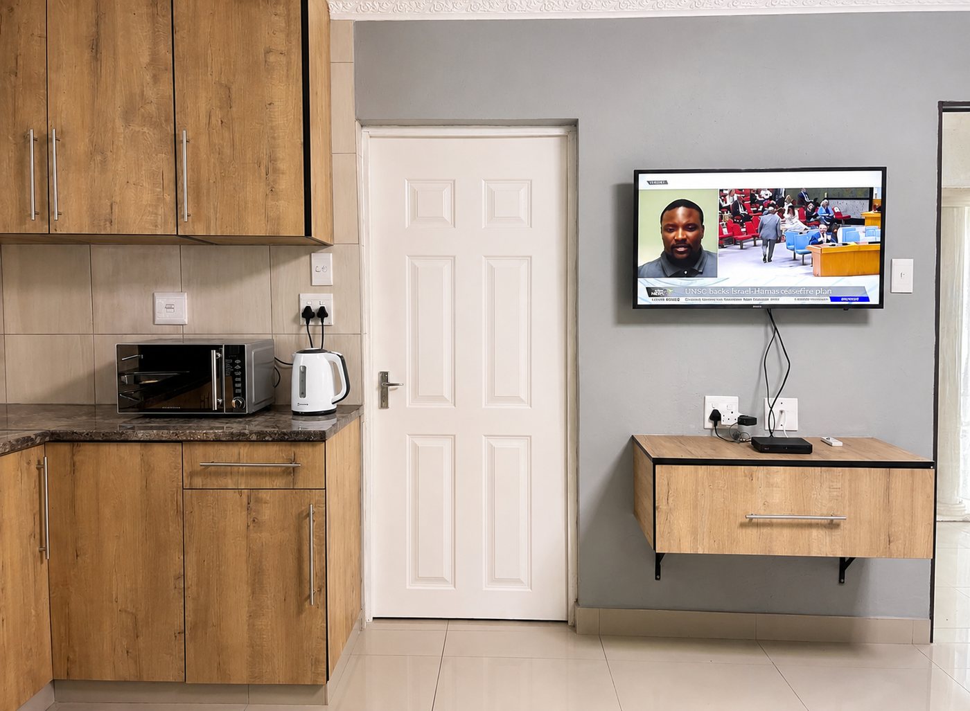 Superior King Room — kitchenette and TV wall