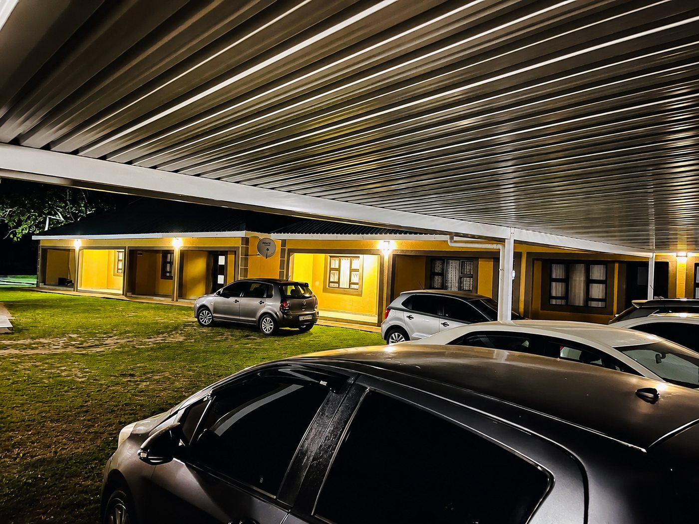 Mashobs Guest House at night with secure covered parking
